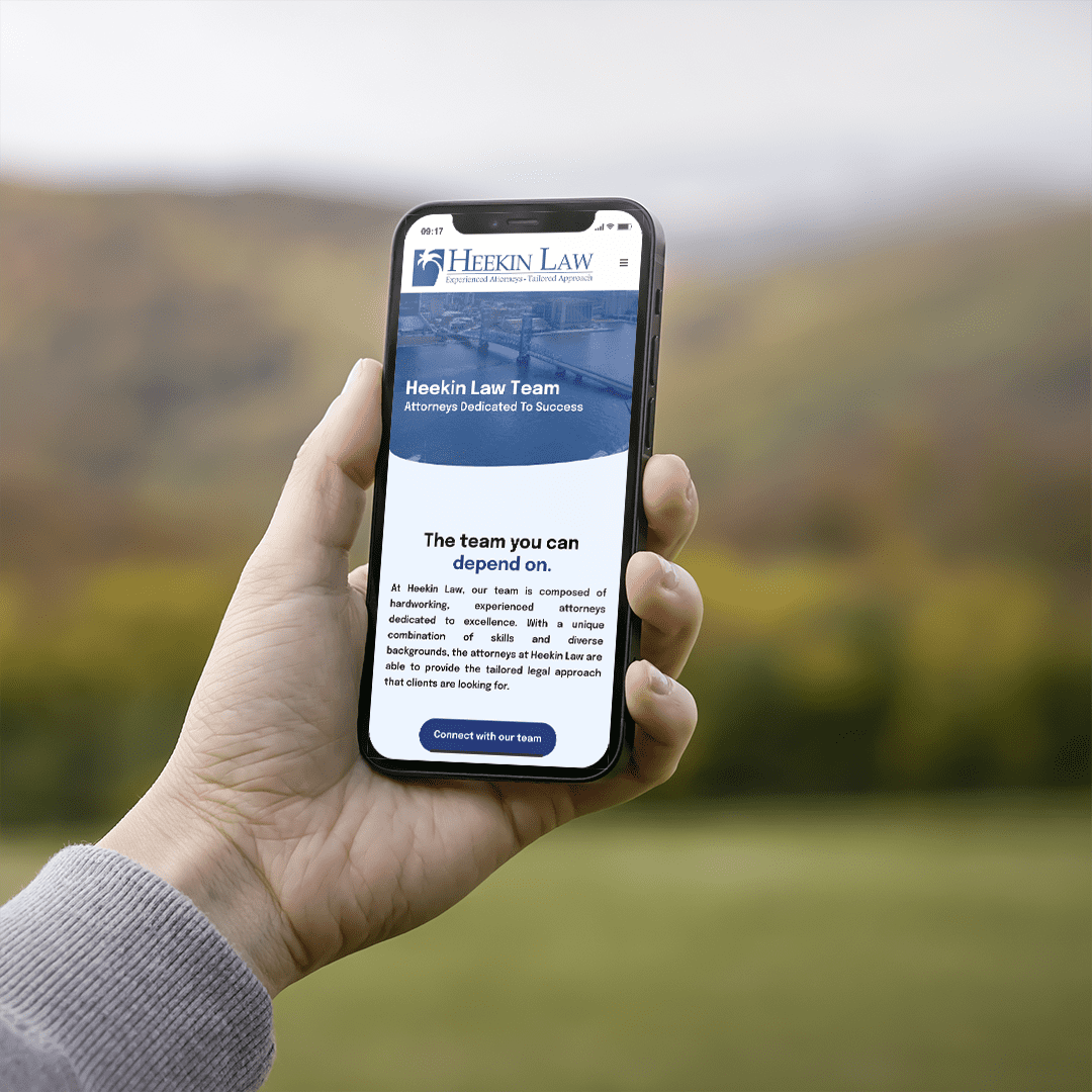 iPhone displaying a law firm website design against an autumn backdrop with colorful leaves, highlighting modern web aestheti