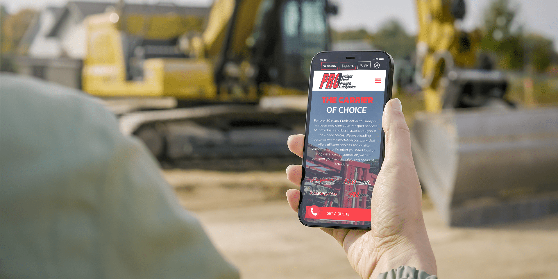 iPhone mockup displaying auto transport multimedia app interface, set against a construction site backdrop.