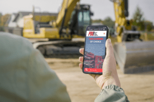 iPhone mockup displaying auto transport multimedia interface amidst construction scenes, highlighting digital design elements