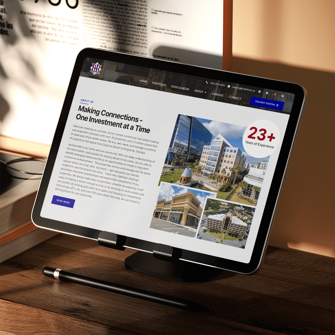 Tablet displaying a real estate portfolio design with a modern interface, showcasing property listings and details.